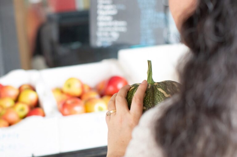 A person holding fresh produce at the market.