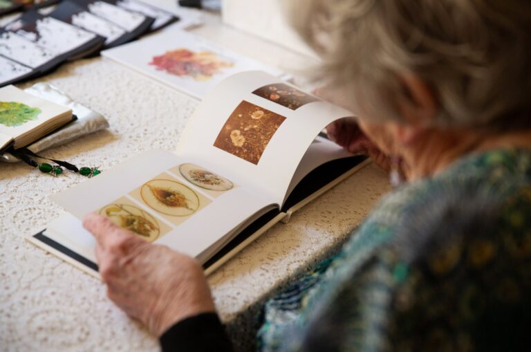 A person looking at the book. The image is taken over the shoulder of the person.