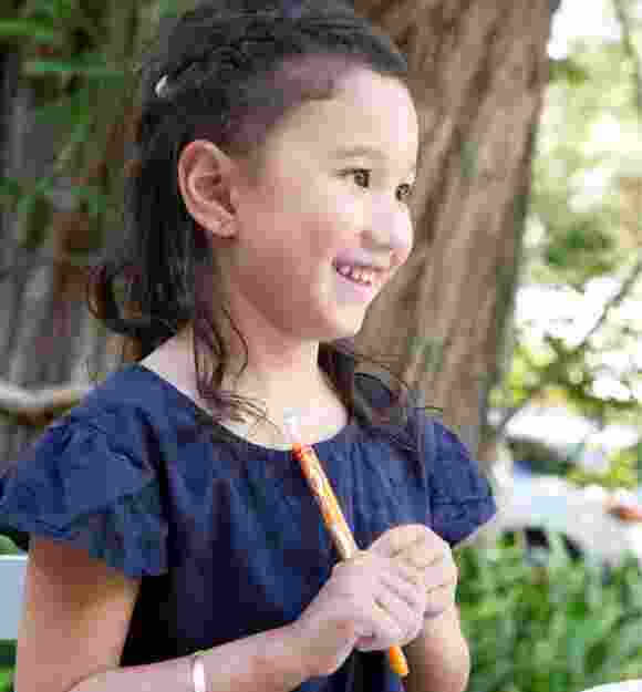 A young child smiling.