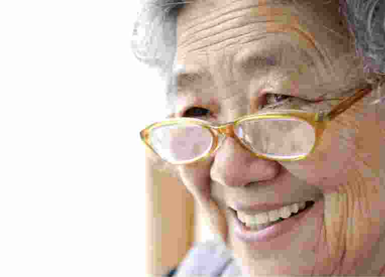 A close up of an older adult person who is smiling.