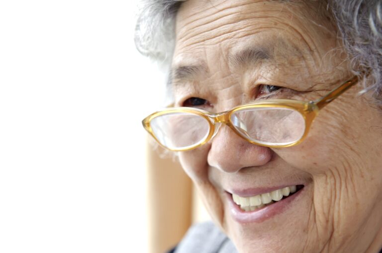 A close up of an older adult person who is smiling.
