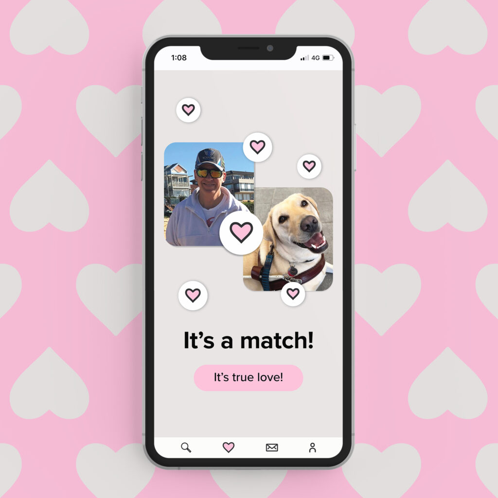 A phone showing the text "It's a match" with a picture of a person and their Guide Dog. Pink hearts surround them.