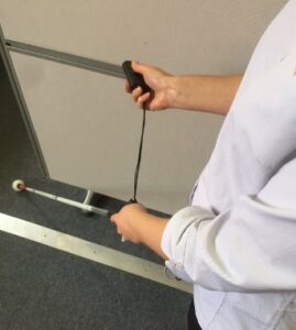 Miniguide being used with long cane.