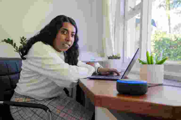 Abby sitting at her desk in front of a laptop