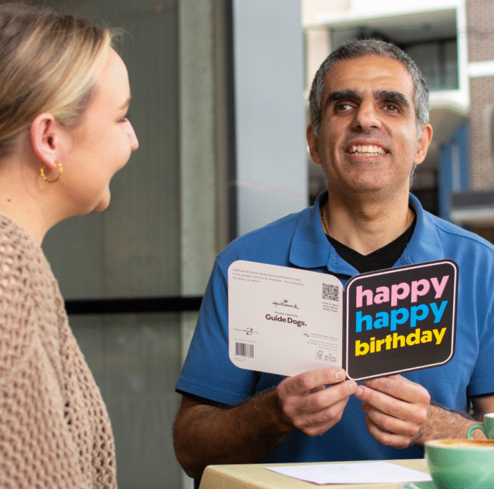 Guide Dog Client, Andrew recieving an accssible card.