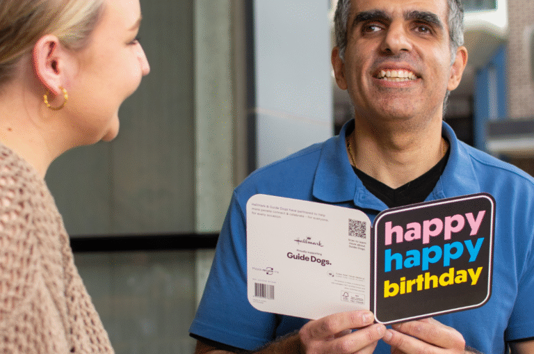 Guide Dog Client, Andrew recieving an accssible card.