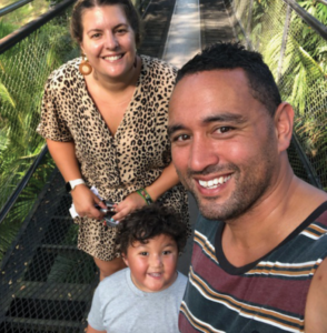 Ezra with his parents on a boardwalk