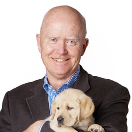 Portrait of Bruce Book and a yellow Labrador puppy