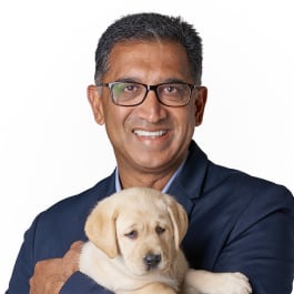 Portrait of Harish Rao with a yellow Labrador puppy