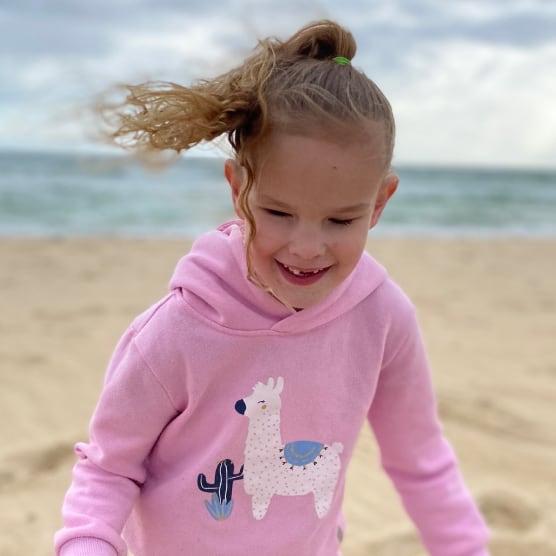 A young girl smiling at the beach