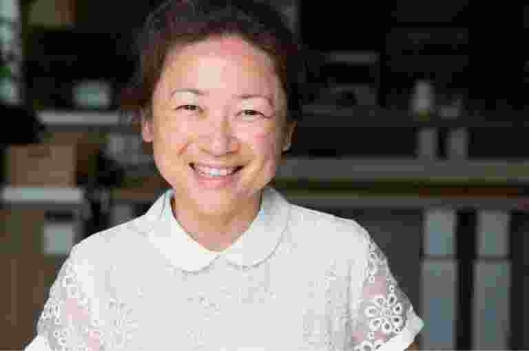 A person with a big smile looking straight at the camera.