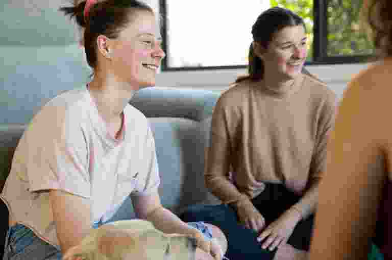 A group of girls sitting and chatting.