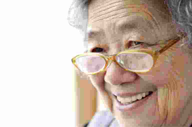 A close up of an older adult person who is smiling.