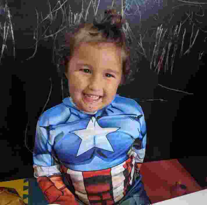 Ezra smiling while wearing a Captain America outfit
