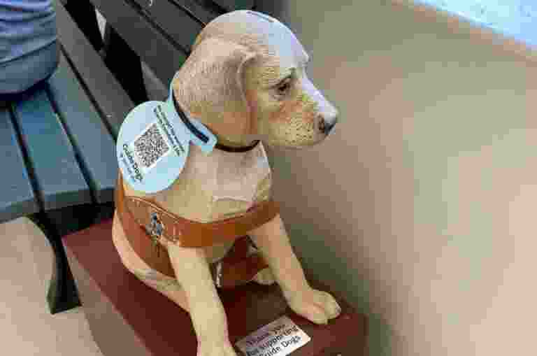 Statue of a Labrador with a QR code.