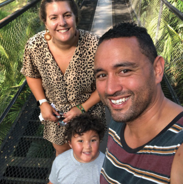 Ezra with his parents on a boardwalk