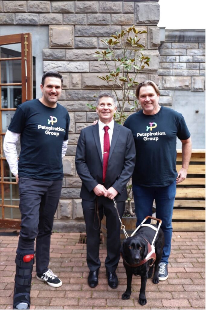 Iain Edwards, Interim CEO Guide Dogs Victoria, with Guide Dog Olympia thanking David and Shane Young and the Petspiration Team at a recent Roadshow