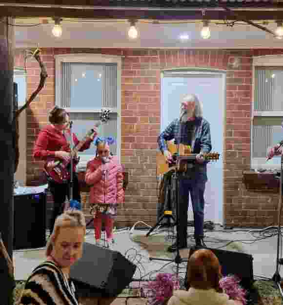 Stella singing with a band