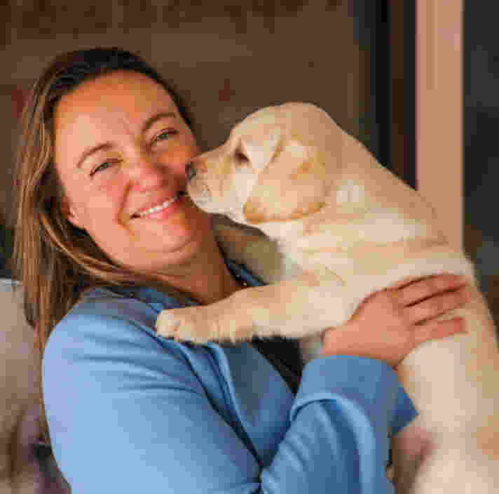 Lisa holding a labrador puppy