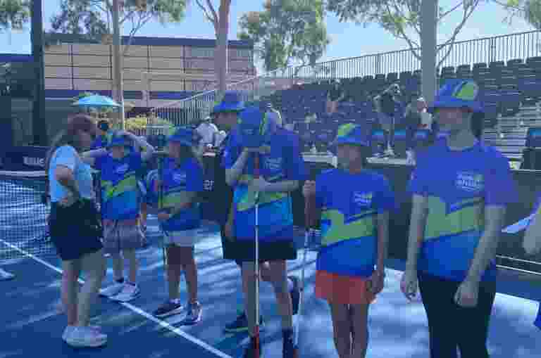 Students line up on the serving line at court 5 at the Australian Open.