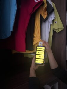 A person scanning a yellow washing clothing label with their phone. 