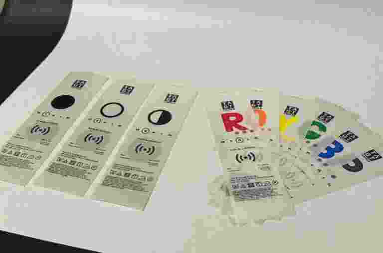 Nine clothing labels with large print letters corresponding to colours.