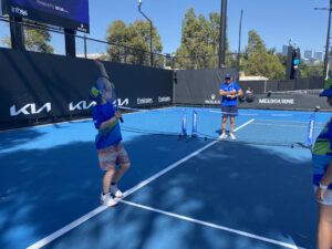 A student practicing a serve. 