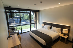 Client rooms, showcasing a large queen bed, desk and tv. 