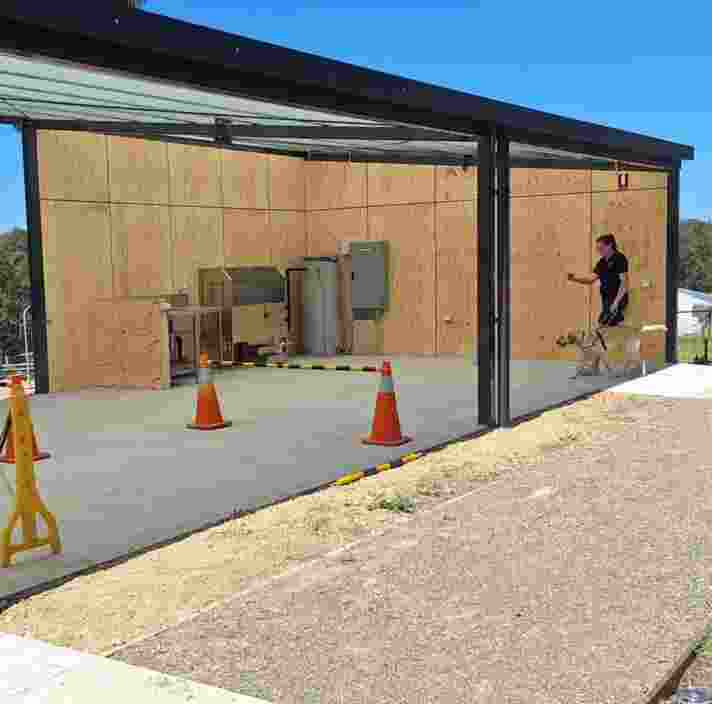 Two Orientation and Mobility Instructors take trainee Guide Dogs through their paces in the new Kent Training Plaza