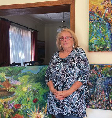 Madeleine Popper in her home surrounded by her art.
