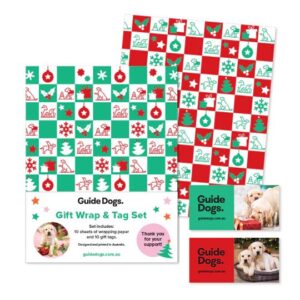 Guide Dogs gift wrap and tag set featuring festive red, green, and white wrapping paper with Christmas-themed patterns and puppy-themed gift tags.