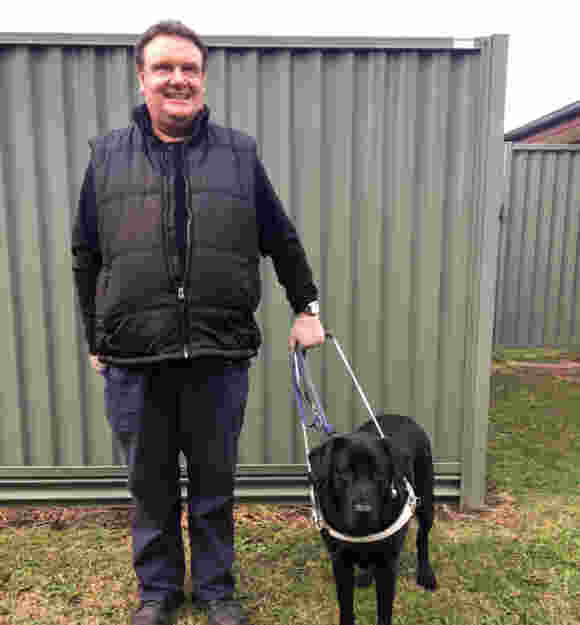 Brent standing with his Guide Dog Zosh