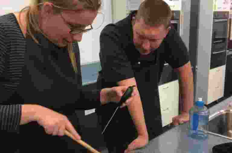 Nate teaching a student with vision loss to cook