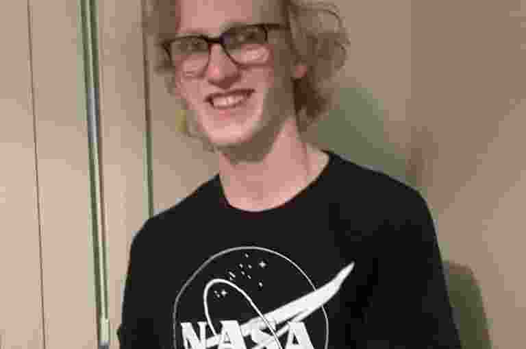 Dominic smiling, wearing a NASA t-shirt