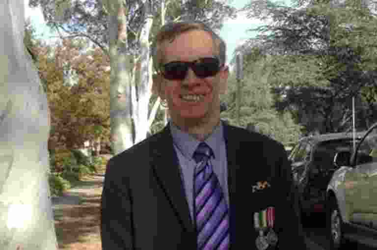 Ted Barend, a Guide Dogs client, facing the camera smiling