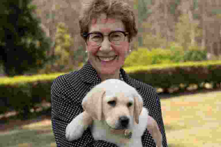 Her Excellency the Honourable Margaret Beazley AO QC, Governor of New South Wales, holding Beazley, the Guide Dog puppy