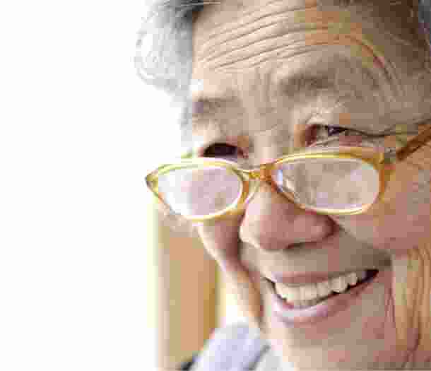 A close up of an older adult person who is smiling.