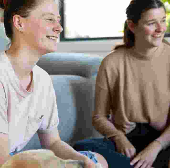 Two people sitting on a couch