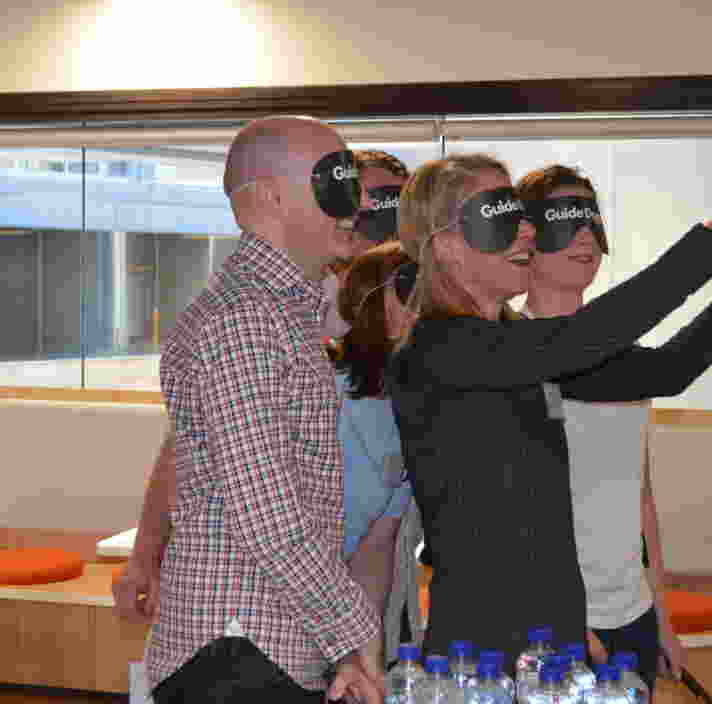 A group of people doing challenge with significant vision loss or blindness