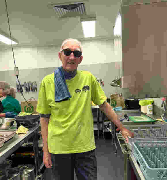 A man standing in a commercial kitchen
