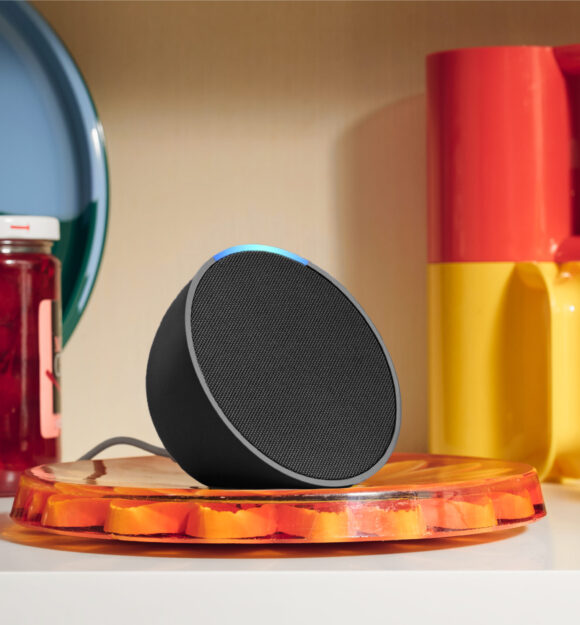 Amazon Alexa sitting next to colourful cups and jars.