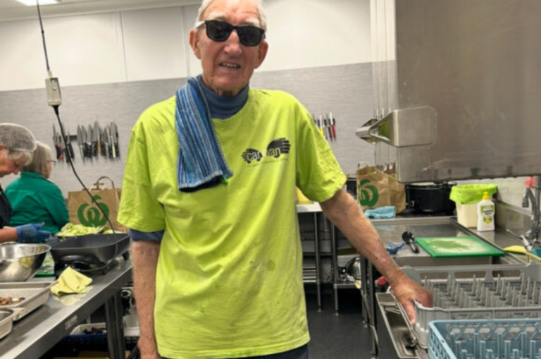 Colin stands in a commercial kitchen.
