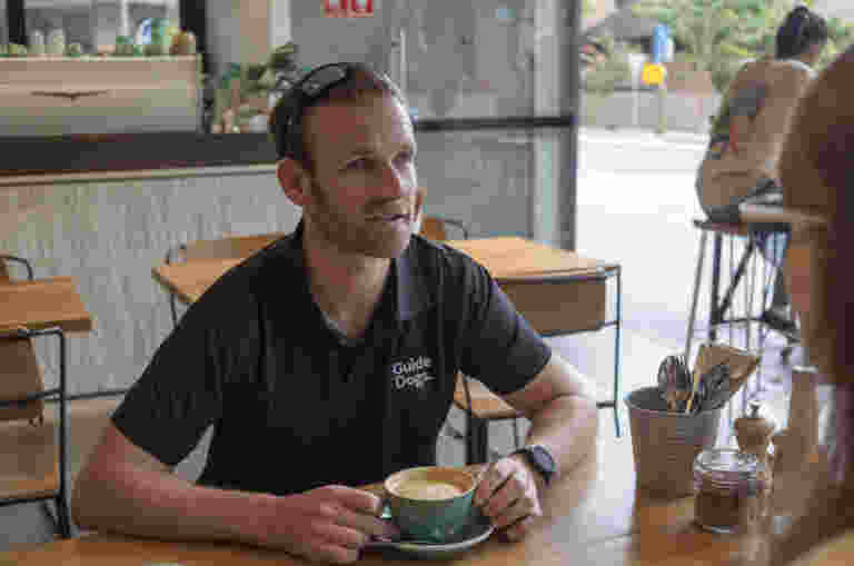 Dan sitting at a cafe.