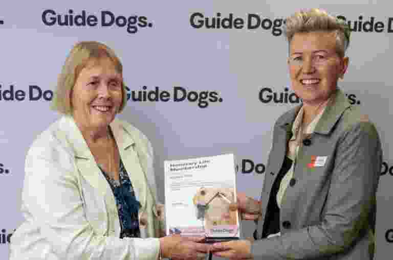 Angela accepting an award from Chair Jacqui Jones.