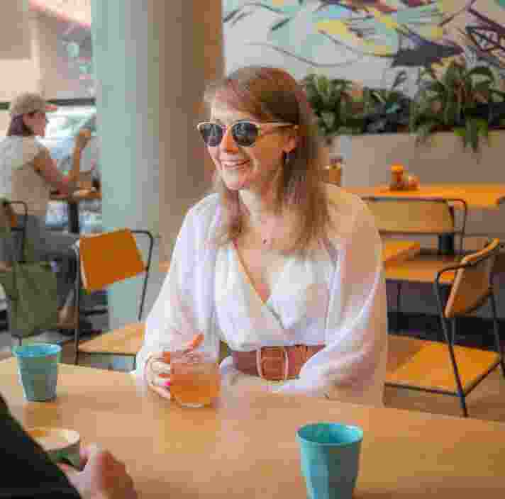 Aimee sitting in a cafe.