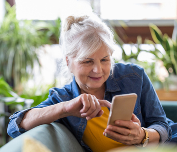 A person using a smartphone on a lounge.