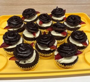 Chocolate cupcakes with frosting in the middle.