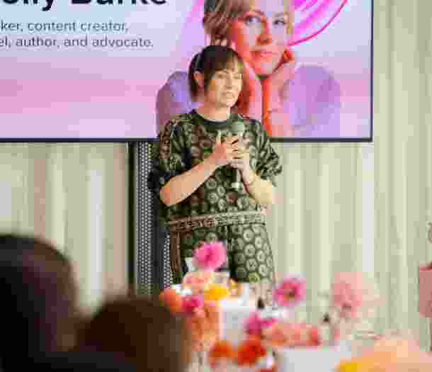 Molly Burke presenting at Beauty Summit.