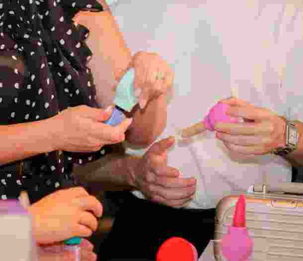 Two people holding products at the beauty summit.