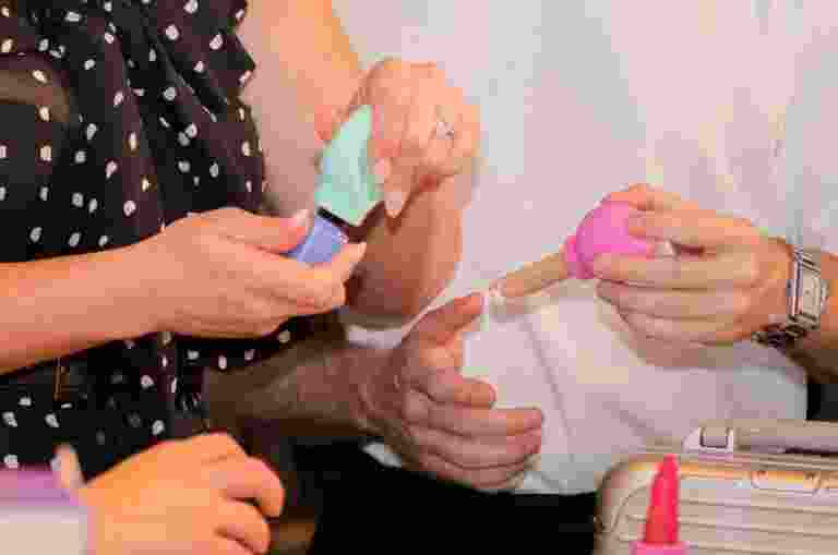 Two people holding products at the beauty summit.